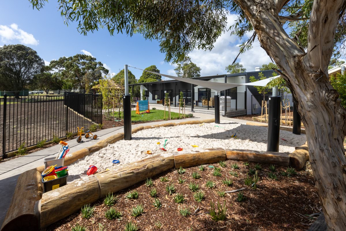 Drysdale Street Kindergarten - photo of a sandpit surrounded by trees and green space