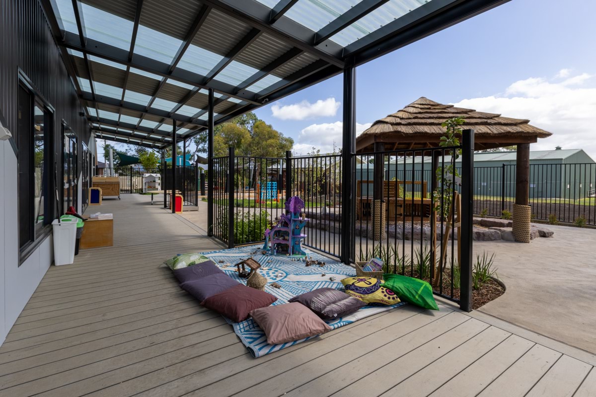 Drysdale Street Kindergarten - photo of an outdoor decking area with a rug and cushions 