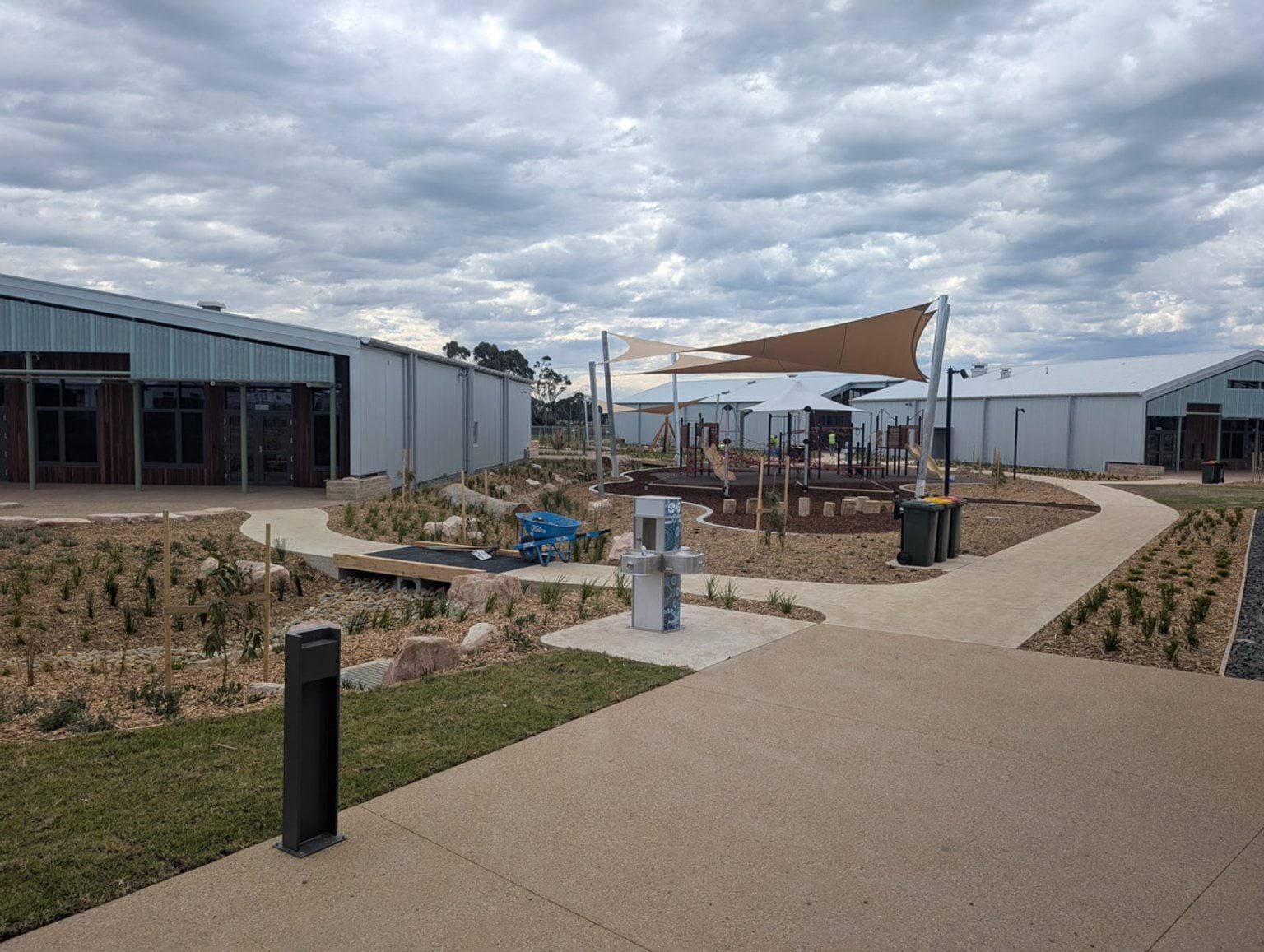 Landscaping completed at Yirrama Primary School. Playground under shadecloth in the background.