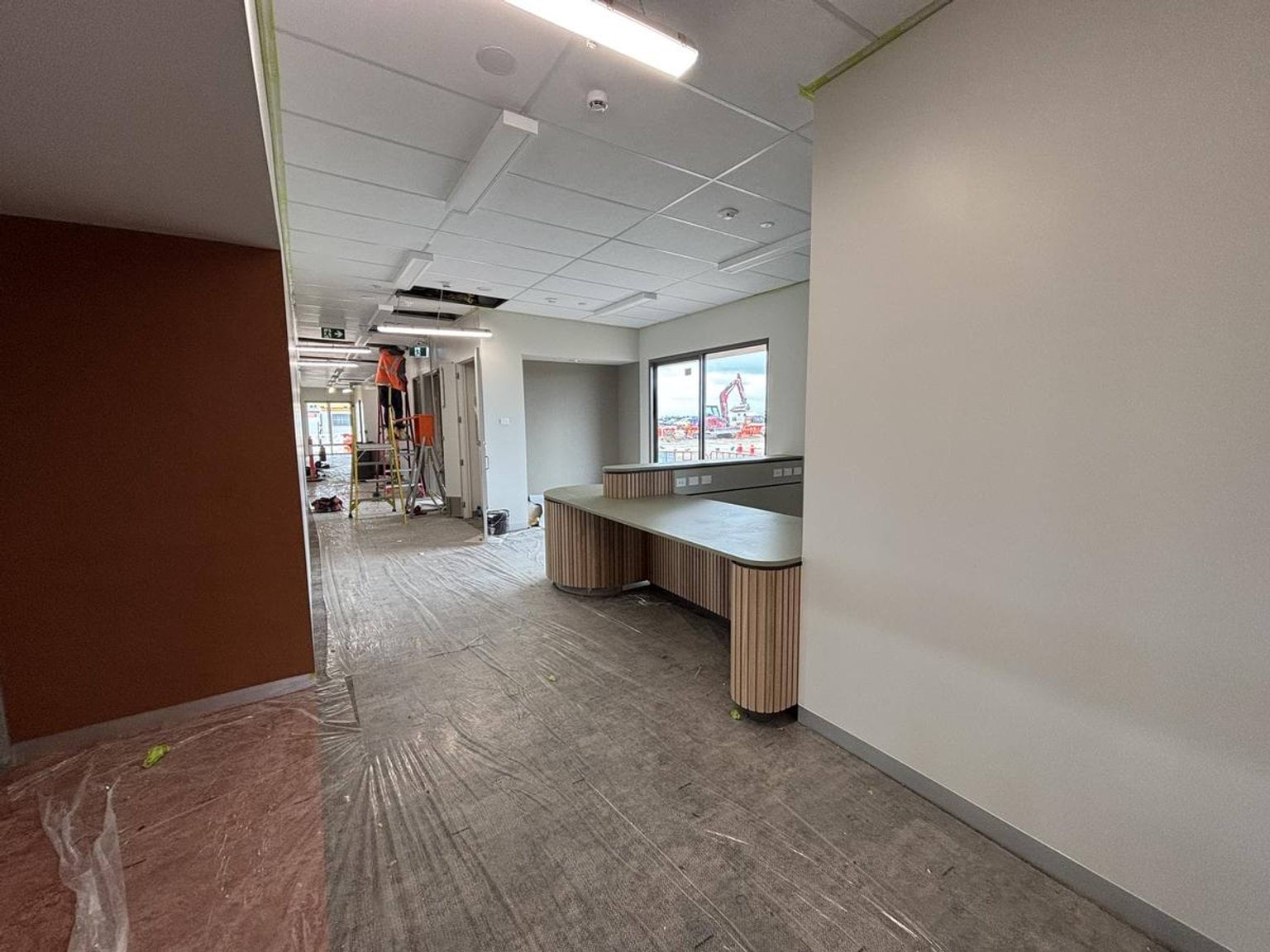 Photograph of interior of Yurran P-9 College Kindergarten main reception with timber desks and a red feature wall