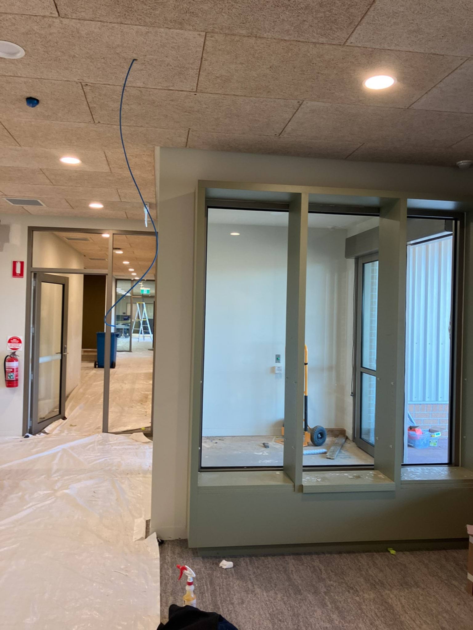 Photo of new hallway with room off to the side and construction equipment