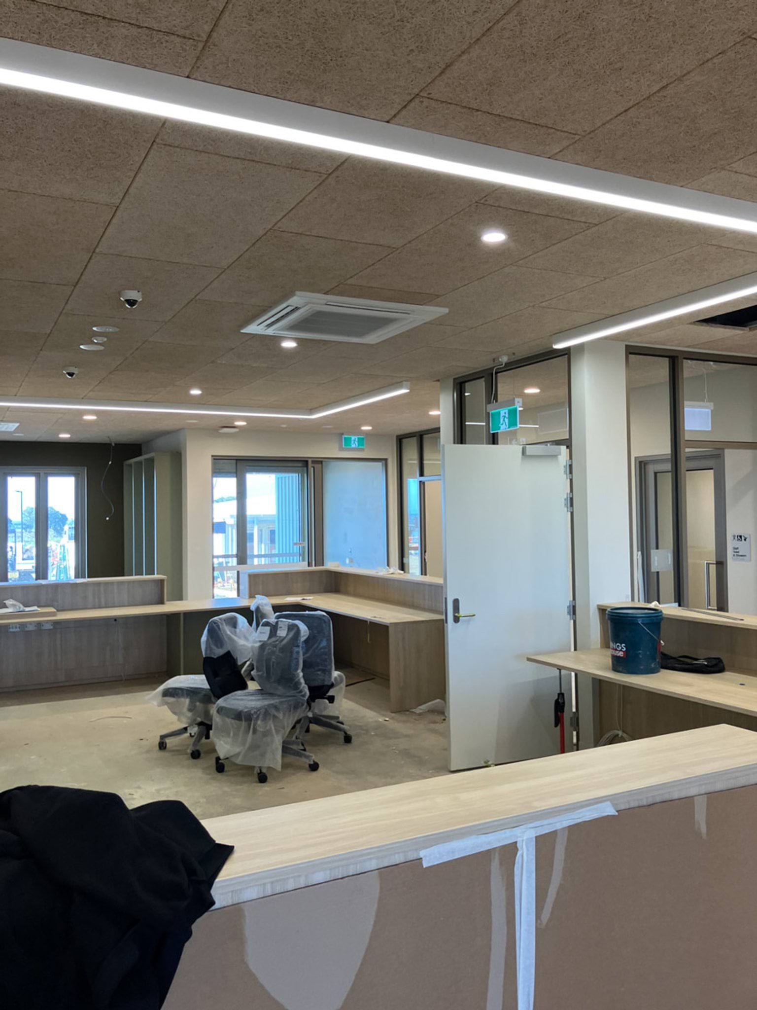 Inside of reception area showing desks and chairs wrapped in packaging